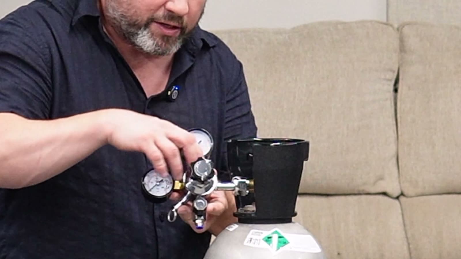 Threading the regulator onto the tank